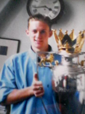 Ray holding the Premier League Cup trophy