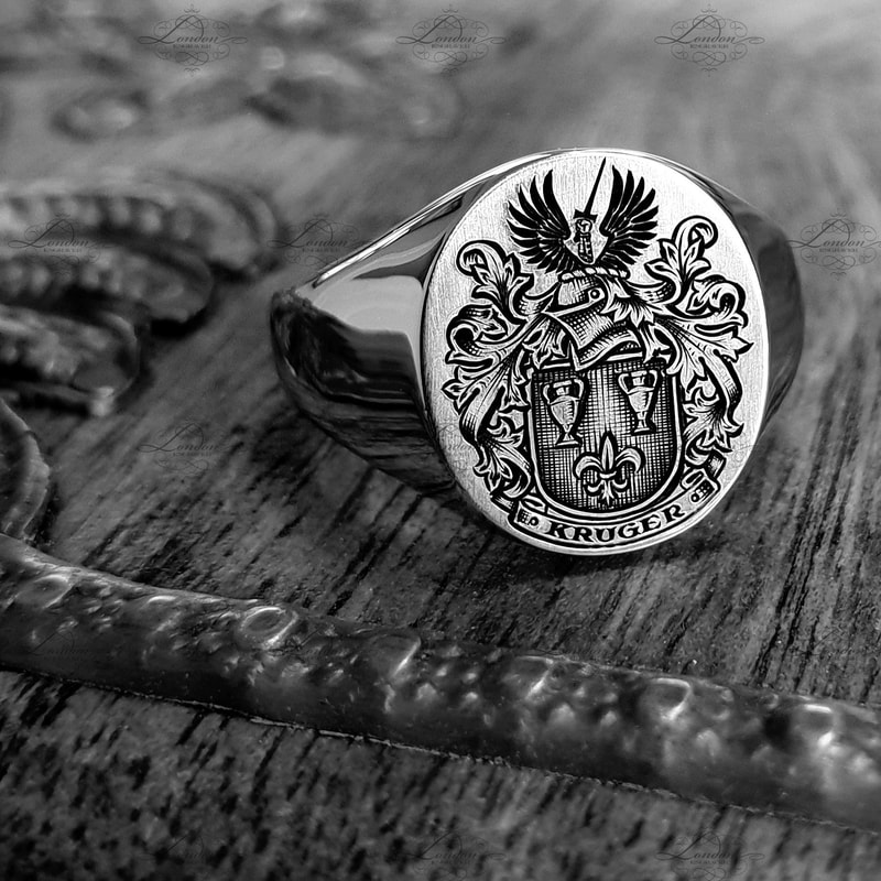 Surface engraved Kruger Coat of Arms, with black enamel. 12x14 Oxford Oval signet ring.
