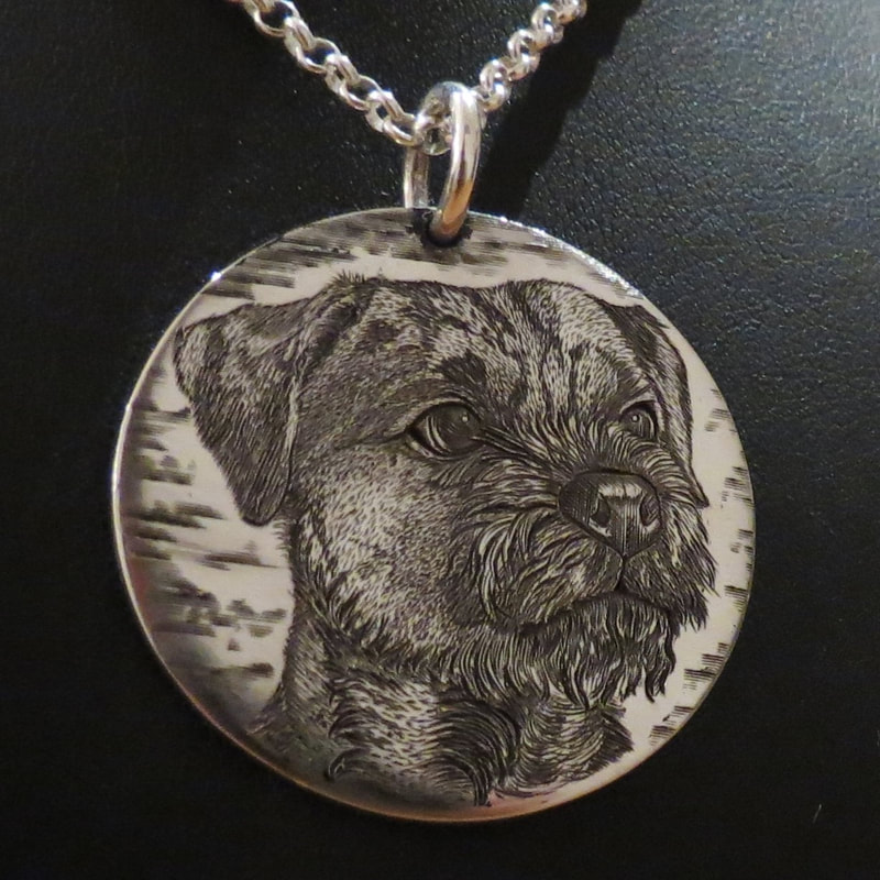Hand engraved dog portrait on a round sterling silver pendant - border terrier