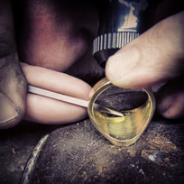 Image of Ray hand engraving an inscription inside a yellow gold signet ring