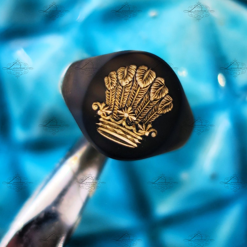 Black sooted signet ring ready to take a wax impression of a seal engraved fleur de lis crest.  Oxford Oval signet ring.