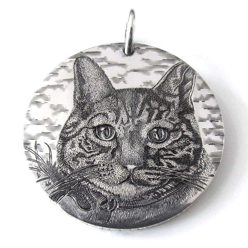 Hand engraved cat portrait on a round sterling silver pendant
